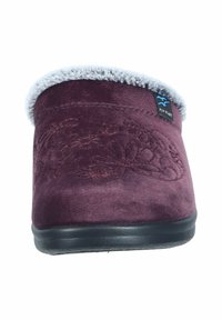 Burgundy suede slipper featuring a soft gray faux fur lining, embossed floral pattern, and a black rubber sole.