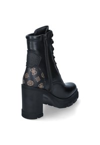 Bottine en cuir noir avec un talon épais, arborant un logo embossé et des accents bruns à motifs à l'arrière. Laçage et fermeture éclair sur le côté.