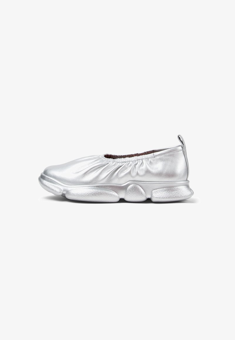 Silver ballet flats with gathered material at the collar, padded sole, and a textured finish on the sole for grip. Soft and lightweight design.