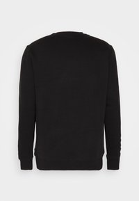 Felpa nera con maniche lunghe, scollatura rotonda e polsini a coste. Realizzata in un morbido tessuto testurizzato con un design semplice e privo di decorazioni.