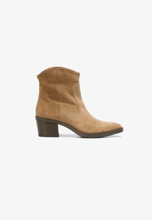 Botine de gleznă din suede bej, cu vârful ascuțit, o siluetă elegantă și un toc de 7,5 cm. Prezintă cusături minime și o textură netedă.