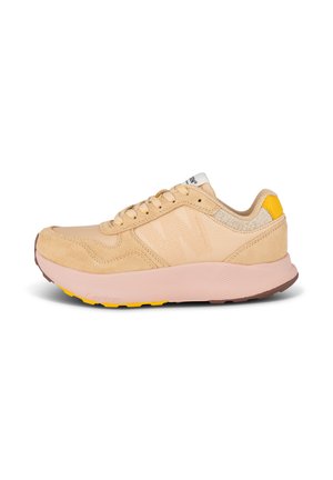 Light beige athletic shoes with a textured fabric upper, suede accents, and a cushioned pink sole featuring yellow and brown details.