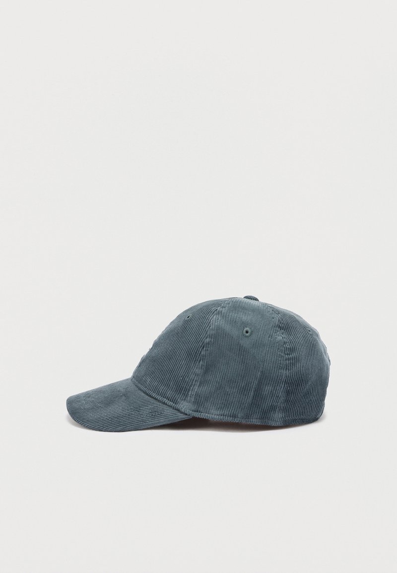 Blauer Cord-Baseballcap, seitlich dargestellt vor einem schlichten weißen Hintergrund.