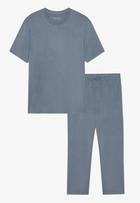 Light blue, short-sleeve t-shirt and matching drawstring pants arranged neatly. Fabric appears soft and comfortable.