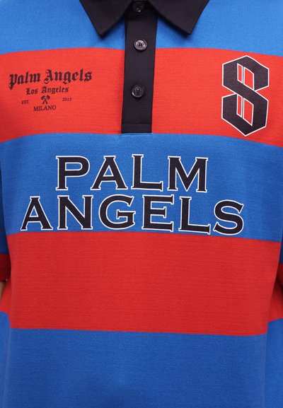 Μπλε και κόκκινο ριγέ πόλο μπλουζάκι με μαύρο γιακά, με το κείμενο "PALM ANGELS" και μαύρο στυλιζαρισμένο λογότυπο "S" στο στήθος.