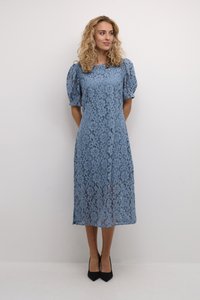 Blue lace midi dress with puff sleeves, floral pattern, and a fitted bodice. Paired with black pointed-toe heels.