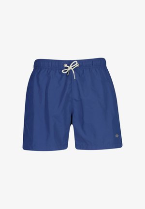 Blaue Herren-Badeshorts mit weißem Kordelzug und kleinem Metalllogo am unteren linken Bein, auf weißem Hintergrund präsentiert.