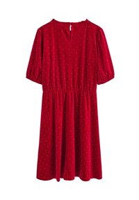 Czerwona sukienka z weluru z krótkimi bufkami, elastycznym pasem i dekoltem w kształcie litery V. Posiada małe srebrne kropki rozsiane po całej tkaninie.