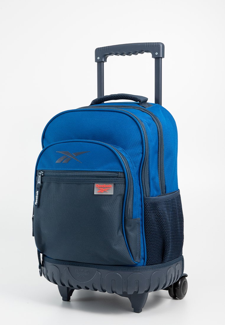 Mochila rodante Reebok en azul y negro con mango telescópico, bolsillo frontal con cremallera, bolsillo lateral de malla y base de plástico resistente con ruedas.