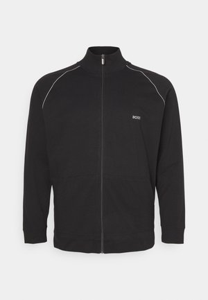 Černá zipová bunda z bavlny, vybavená vysokým límcem, dlouhými rukávy a bílými lemy na ramenou. Obsahuje detail s logem.