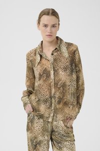 Camicia button-up con stampa zebra marrone e beige, con colletto, maniche lunghe e vestibilità rilassata. Il noto motivo testurizzato emula la pelle di rettile.