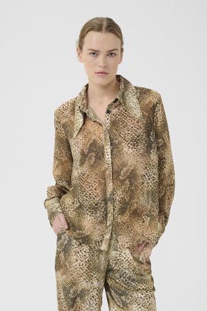 Brun og beige skjorte med slangeskinnsmønster, knappestolpe, krage, lange ermer og avslappet passform. Merkbar teksturert mønster som etterligner reptilhud.