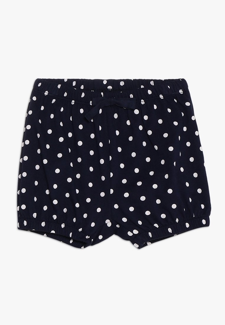 Shorts pour bébé bleu marine à pois blancs, avec une taille élastique ornée d'un nœud papillon et des ourlets élastiques aux jambes.