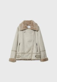 Beige shearling jacket with a wide collar, zip closure, and two front zip pockets. Features soft fur lining and ribbed accents on the sleeves.