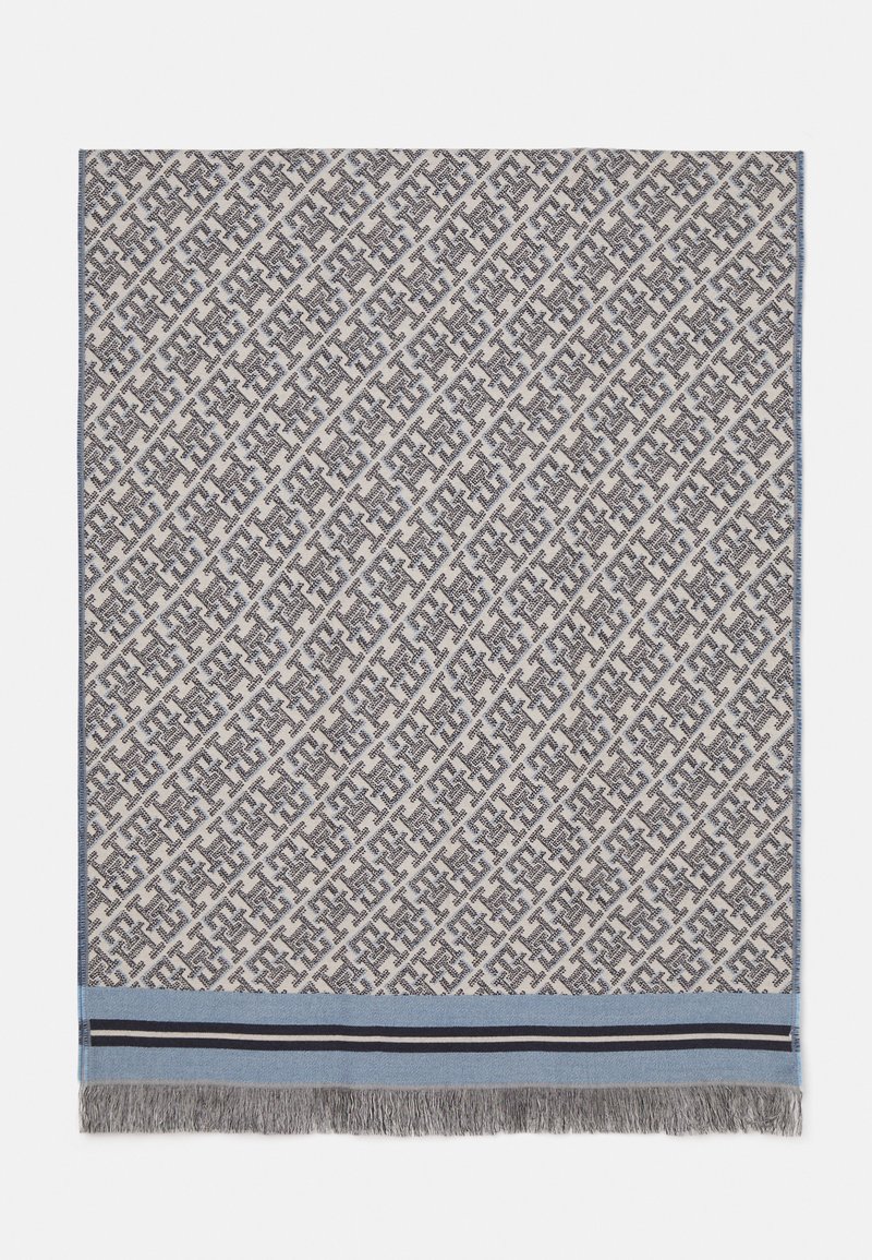 Geweven plaid in crème en grijs met een geometrisch patroon, voorzien van een blauwe accent en zwarte strepen aan de zoom, afgewerkt met franjes.