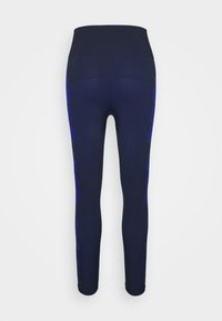 Leggings navy avec une taille haute, présentant des accents latéraux bleus et une texture lisse. Ajustés, se resserrant aux chevilles.
