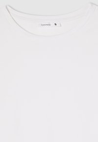 T-shirt bianco in cotone con scollo rotondo, etichetta che legge "Terranova", taglia piccola, texture liscia, senza motivi o elementi metallici visibili.