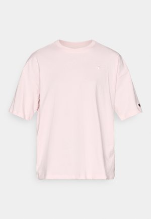 Lyserød bomulds-T-shirt med korte ærmer. Har et diskret logo på brystet og en kontrastfarvet logodetalje på ærmet.