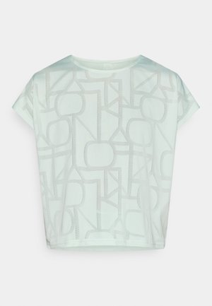 Haut vert menthe clair à manches courtes présentant un motif géométrique dans une teinte plus foncée de vert. Tissu doux avec une coupe décontractée et courte.