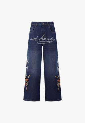 Denim wide-leg jeans in dark blue with 'ed hardy' logo in white and decorative graphic design featuring a heart and dagger in colors.