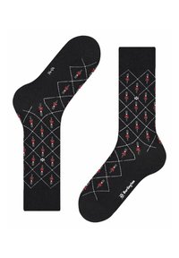 Calze nere con un motivo a rombi che presenta figure di soldati rossi. Realizzate in tessuto morbido con linee bianche incrociate e dettaglio del logo sulla parte del piede.