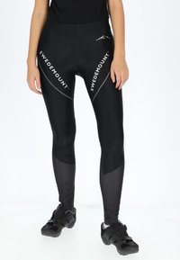 Black cycling tights with a fitted design, featuring "SWEDEMOUNT" branding, textured accents, and padded insert for comfort.