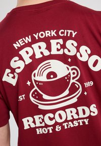 Maroon cotton t-shirt featuring white graphic text and a coffee cup illustration. Includes "New York City Espresso Records" and "Hot & Tasty."
