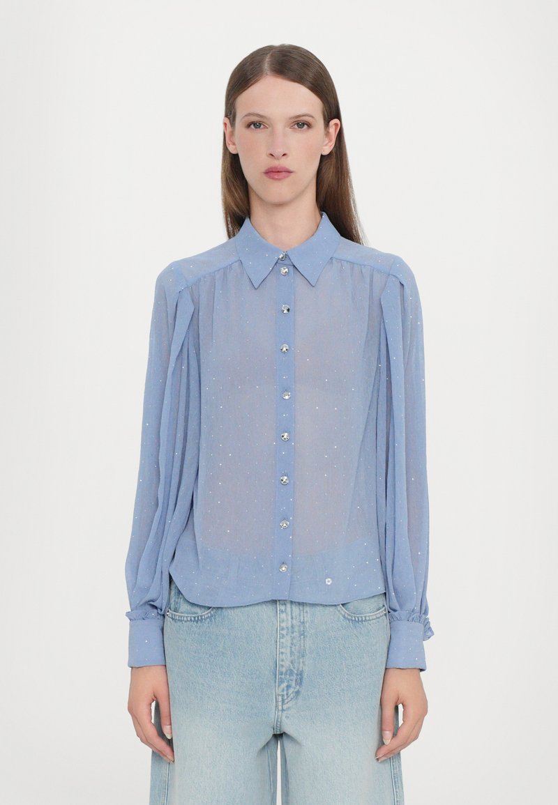 Light blue sheer blouse with long sleeves, button-down front, silver button accents, and subtle sparkles throughout. Casual fit.