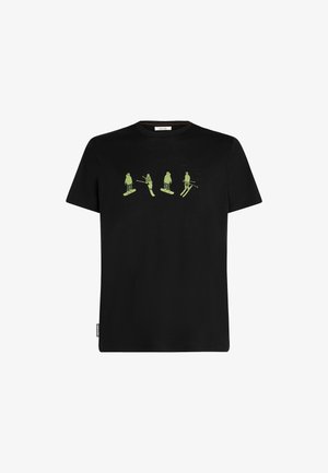 Black cotton t-shirt featuring four green graphic figures in skiing and snowboarding poses. Short sleeves and crew neck design.