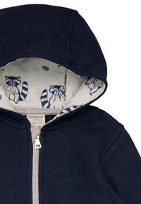 Felpa con zip color blu navy, dal tessuto esterno morbido e un interno beige a fantasia con illustrazioni di procioni.