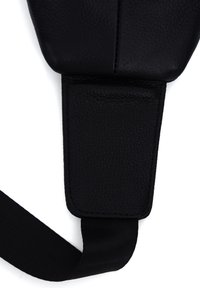 Black leather shoulder strap with a textured surface, featuring a smooth padded section and sturdy fabric attachment point.