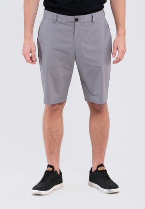 Gray shorts made of lightweight fabric, featuring a flat front, button closure, and side pockets. Paired with black sneakers.