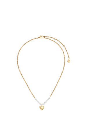 Delicate gold chain necklace with small white beads and a heart-shaped gold pendant engraved with floral designs.