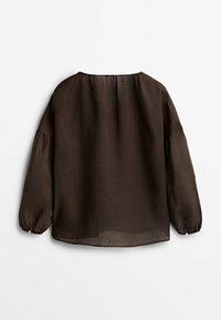 Chemise longue à manches longues dans une coupe décontractée, fabriquée en tissu léger. Dotée d'un col rond et de poignets élastiqués. Design minimaliste, couleur uni.