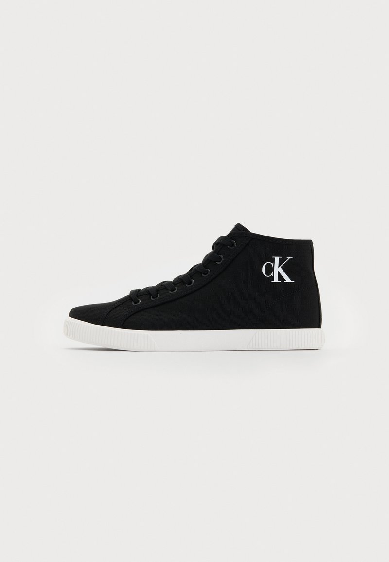 Black canvas high-top sneaker featuring white laces, a white sole, and a logo in the shape of "cK" on the outer side.