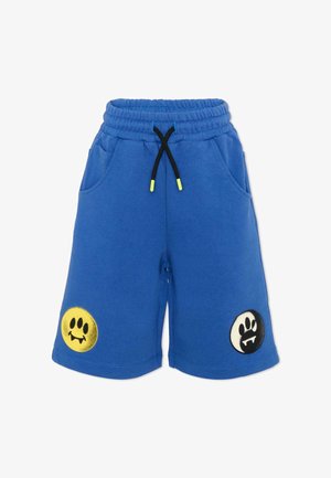Shorts à taille élastique bleue avec cordon noir, ornés de patchs smiley en forme d'empreintes de pattes jaunes et noires près des ourlets des jambes.