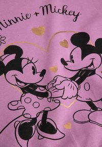 Fioletowa tkanina z grafiką Myszki Miki i Minnie trzymających się za ręce, obrysowanych czarnym kolorem z złotymi sercami oraz w sukience w groszki Minnie.