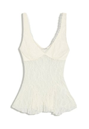 Haut sans manches en dentelle blanche avec un corsage ajusté, un ourlet évasé et un décolleté profond arrondi.