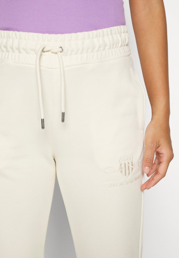 TONAL SHIELD - Tracksuit bottoms - linen4