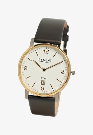 Montre ronde avec cadran blanc, lunette dorée, index horaires noirs et un affichage de la date à 6 heures. Bracelet en cuir marron à texture lisse. Marque : Regent, modèle : Titan.