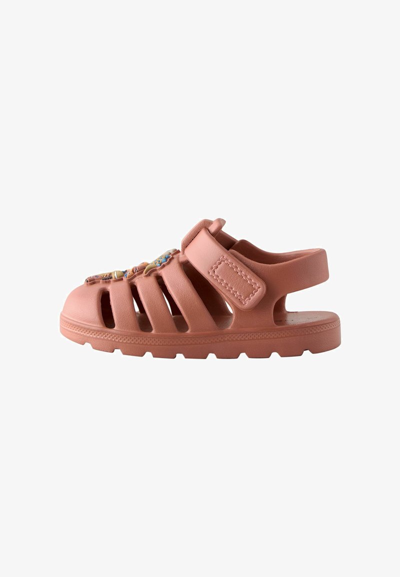 Pink rubber sandal with multiple ventilation holes, adjustable strap, and textured sole. Features decorative accents on the front.
