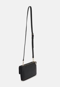 Calvin Klein RELOCK CROSSBODY BAG - Umhängetasche - black