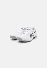 White athletic shoes with a mesh upper, featuring a black logo and accents, rounded toe, and textured rubber sole for traction.