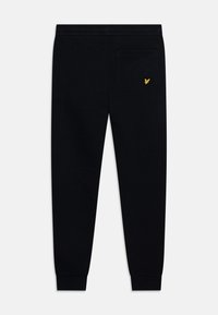 Pantalons de jogging noirs en mélange de coton, dotés d'un logo jaune sur la poche arrière, de poignets côtelés et d'une taille élastique.