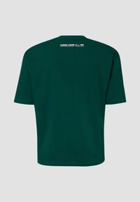 Dark green short-sleeve t-shirt shown from the back with white text "HANGING AROUND Since 1950" near the neckline.