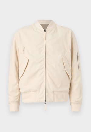 Veste bomber beige clair en mélange de coton. Dotée d'une fermeture éclair, de deux poches avant et d'une poche sur la manche. Poignets et ourlet côtelés.