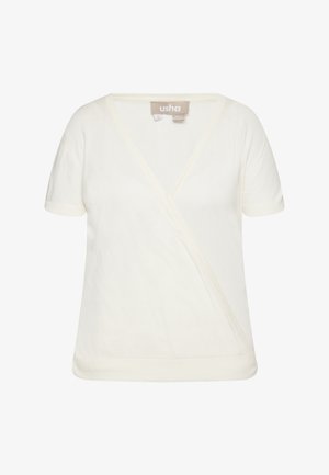 Kremast bluzica z v-izrezom in zavitim dizajnom ter kratkimi rokavi, izdelana iz mehkega materiala. Opremljena je s preprostim dizajnom z minimalnimi šivi in brez vidnih vzorcev ali dodatkov.