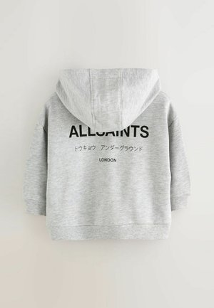 Vaaleanharmaa huppari, jossa musta teksti "ALLSAINTS", japaninkielisiä merkkejä ja "LONDON" painettuna selkäpuolelle.