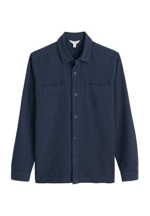 Navy button-up shirt made of a textured fabric. Features a pointed collar, two front pockets, and long sleeves with buttoned cuffs.