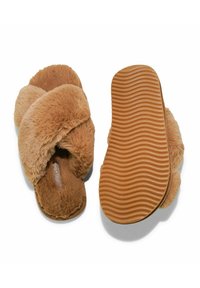 Fuzzy brown slippers with crisscross strap design, soft texture, and a textured rubber sole featuring wavy ridges for traction.